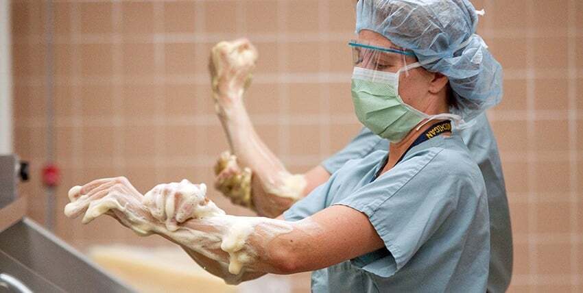 doctor scrubbing up for surgery