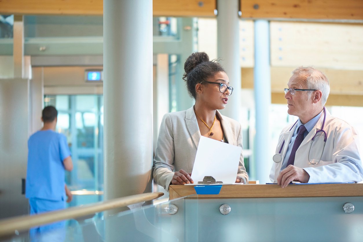 Accreditation Regulator speaking to Doctor in Hospital Lobby