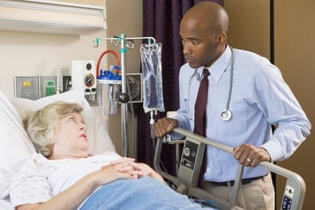 Doctor talking to a patient in hospital bed