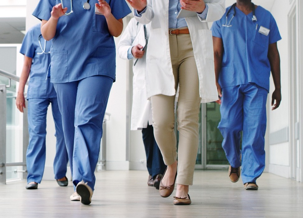 Group of Nurses walking with Woman in Suit-1-2