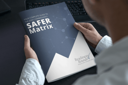man holding a magazine titled The Joint Commissions SAFER Matrix guide