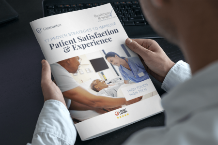 a man holding a magazine titled Proven Strategies to Improve Patient Satisfaction ebook