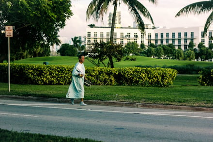 a hospital patient in a gown walking down the street